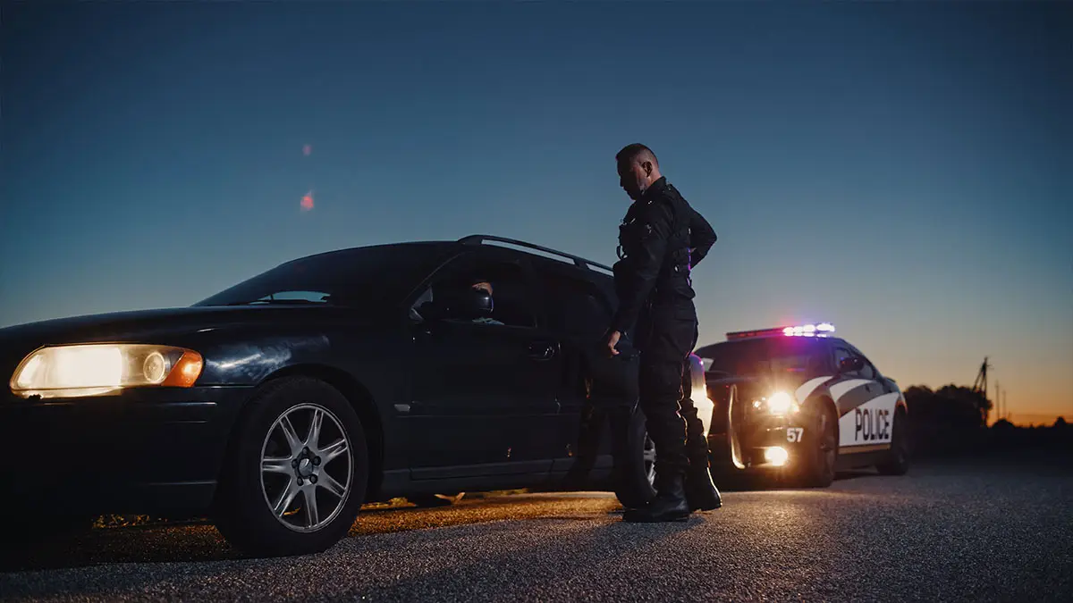 A police officer pulls over a car and asks for license and registration.