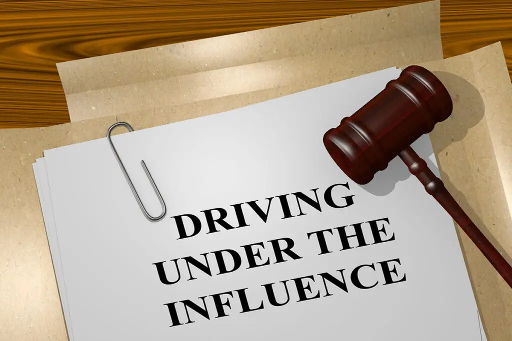 A wooden gavel is on top of a legal paper with the words reading 'Driving Under The Influence'.