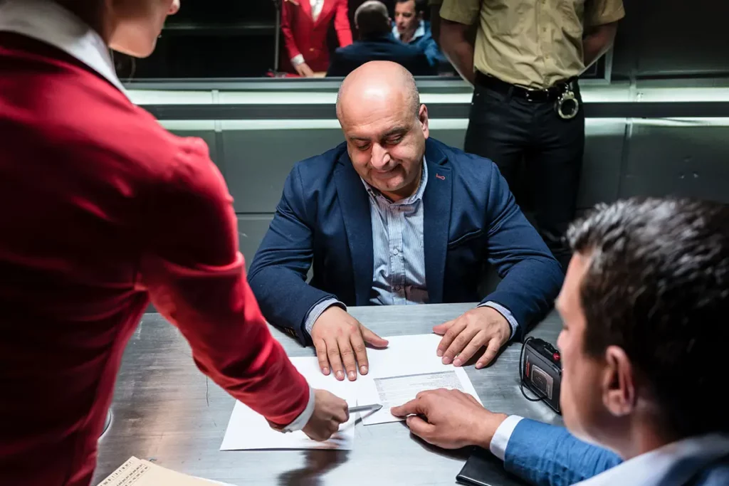 Lawyers having client sign an agreement in precinct.
